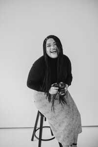 Wedding Photographer, Katt Leon headshot sitting on bar stool