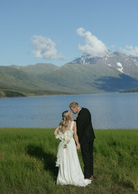 A couple standing next to Eklutna Lake.