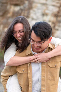 Bride and groom have fun with a piggyback ride on their wedding day