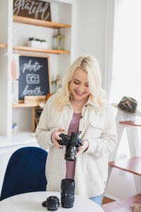 Girl with camera in a bright and airy room