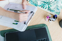 Close-up of a Liv Med Spa specialist in Sioux Falls reviewing medical weight loss progress on a clipboard with charts.