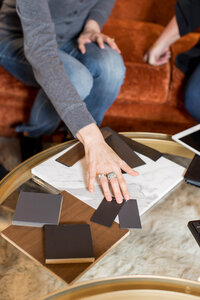 a woman touching color swatches for a home