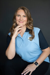 Image of a business women seating wearing a blue top