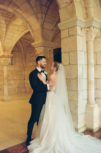 Newlywed photos in a historical stone venue at a destination wedding | SushDigitalMedia
