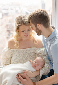 parents and newborn baby in nursery