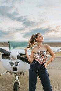Aviation-themed senior portrait girl with plane Tri Cities