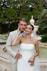 couple at wedding day in front of water fountain
