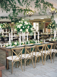 A breathtaking reception setup adorned with greenery and white florals