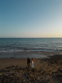 Bride and Groom walking on beach in santa barbara california having a private moment at Ritz Carlton Bacara.