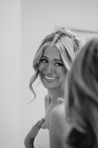 Walking down the aisle on her wedding day, a bride walks with 2 men on each side. They're on the coast in NC.