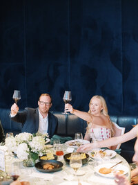 Stylish couple enjoying a rehearsal dinner at Quirk Hotel with elevated design and fine dining, captured by a destination wedding photographer in Virginia