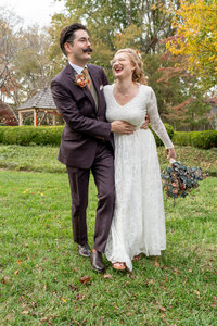 Bride is smiling at her husband during couples photos on their wedding day.
