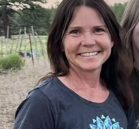 Smiling client sharing their positive experience with Zoe Schroeder’s fitness and nutrition coaching program, showcasing transformation and progress.