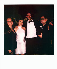 Polaroid photo of Dominique and Javi posing with a newlywed couple at a wedding celebration — a behind-the-scenes look at the film wedding photographers behind Castillo Holliday Photo + Film