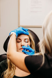 Woman receiving a botox injection from a nurse practitioner