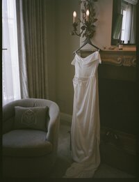 bride getting ready for wedding wearing pearl veil in black and white