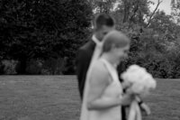 black and white photo of bide and groom walking