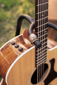 Close-up of guitar with wedding ring resting on it during couples session in New Braunfels, Texas.