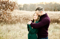 Emotional photo of husband embracing wife at a family session at Edward L. Ryerson Conservation Area