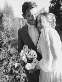 bride and groom by flowers