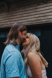 A couple kisses while smiling in downtown Nashville Tennessee