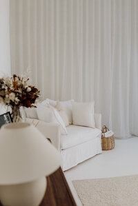 A couch and sheer curtains detail the beautiful christchurch family, newborn and maternity photography studio