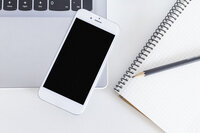 mobile-phone-laptop-with-pencil-notebook-white-table_23-2147854261
