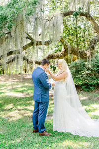 bride and groom sharing a first look at Legare waring house