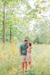 Engagement photo by Victoria Hunt Photography with pink flowers blooming