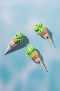 Mint Ice Cream in Cones on Blue Background - Daylight Donuts