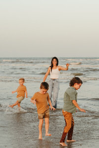 family playing in the water at corpus christi beach