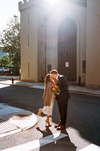 Husband and wife kissing after their city hall ceremony — captured by a film wedding photographer at Castillo Holliday Photo + Film.