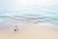 drone portrait of bride in large fluffy gown photographed on a maui beach at sunrise