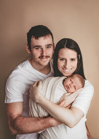 Image of new parents with their baby at a studio newborn photography session by Hobart Newborn Photographer, Lauren Vanier