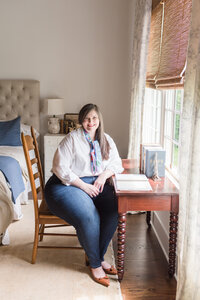 Lauren sits at her antique desk in her bedroom