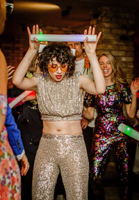Bride in silver sequens dancing at her wedding reception at Severndroog Castle