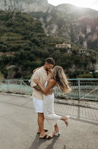 Bride and groom kissing on a mountain overlook, captured during an intimate Utah elopement.