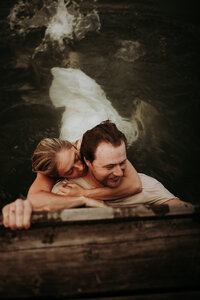 Couple holding each other in the water.