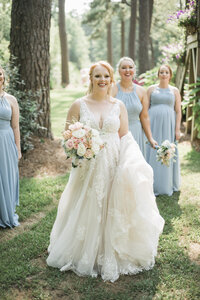 bride walking with bridesmaids and smiling
