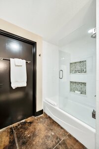 Bathroom with walk-in shower  in this 3-bedroom, 2-bathroom luxury condo in downtown Waco, TX