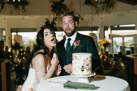 A wedding couple eating cake