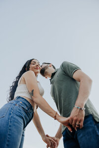 Shot from below, of a guy kissing his girl on the cheek