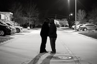 Photo of San Antonio Wedding Photographers Irene Castillo and David Castillo kissing in the snow at night