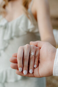 arkansas photo of fiance showing off her engagement ring while her fiance hold her hand