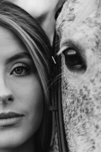 Half of a females face on the left hand side of the image with half of a horses face on the right hand side