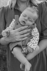 Newborn dozes in new mother's arms