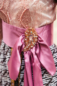 A close-up of a pink Indonesian wedding dress, showcasing the delicate details and vibrant hues that make this traditional attire a stunning and culturally rich masterpiece