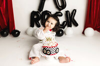 One year old cake smash with little boy dressed as Elvis