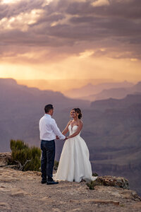 Groom standing at the Grand Canyon, looking out over the vast landscape, a moment of calm before the elopement ceremony