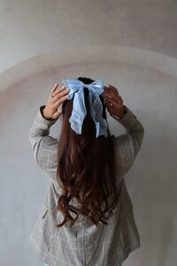 Professional portrait of Kemotion co-owner with hair styled in a bow, ready to start your website.